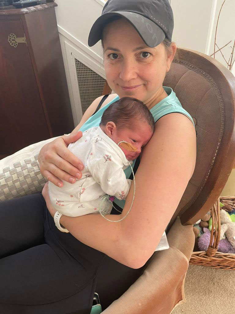 A woman holding a newborn